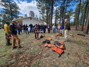 Community volunteers observing during a Chainsaw 101 training in the Summit Lake area of Montezuma County
