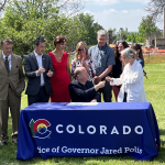 Image of a Colorado Bill signing featuring Governor Pollis and others