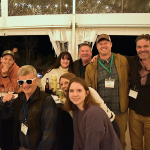 Conference attendees pose for a photo at a social event