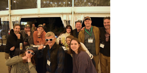 Conference attendees pose for a photo at a social event